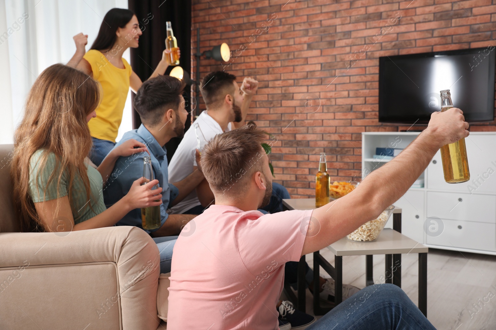 Photo of Group of friends watching football at home