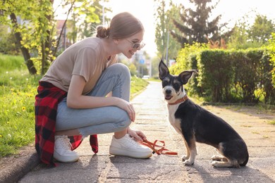 Photo of Teenage girl with her cute dog in park