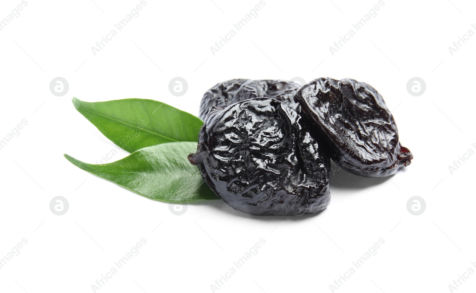 Photo of Tasty prunes and leaves on white background. Dried fruit as healthy snack