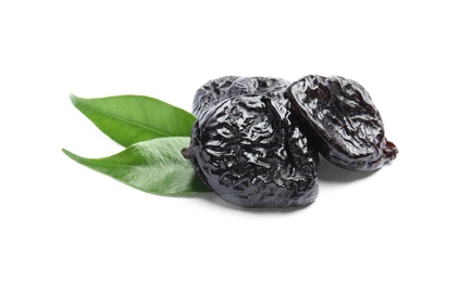 Photo of Tasty prunes and leaves on white background. Dried fruit as healthy snack