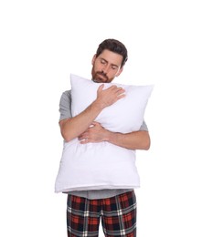 Photo of Sleepy handsome man hugging soft pillow on white background
