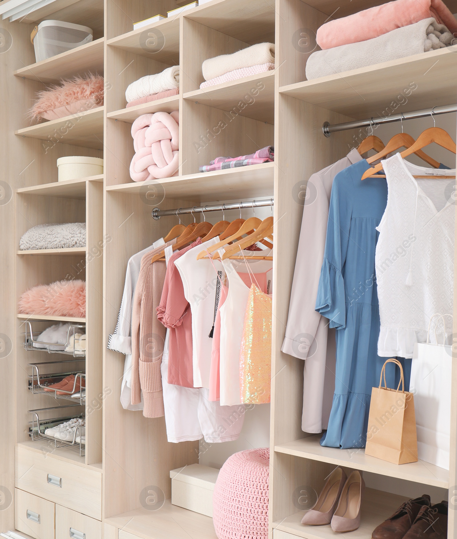 Photo of Stylish clothes, shoes and accessories in large wardrobe closet