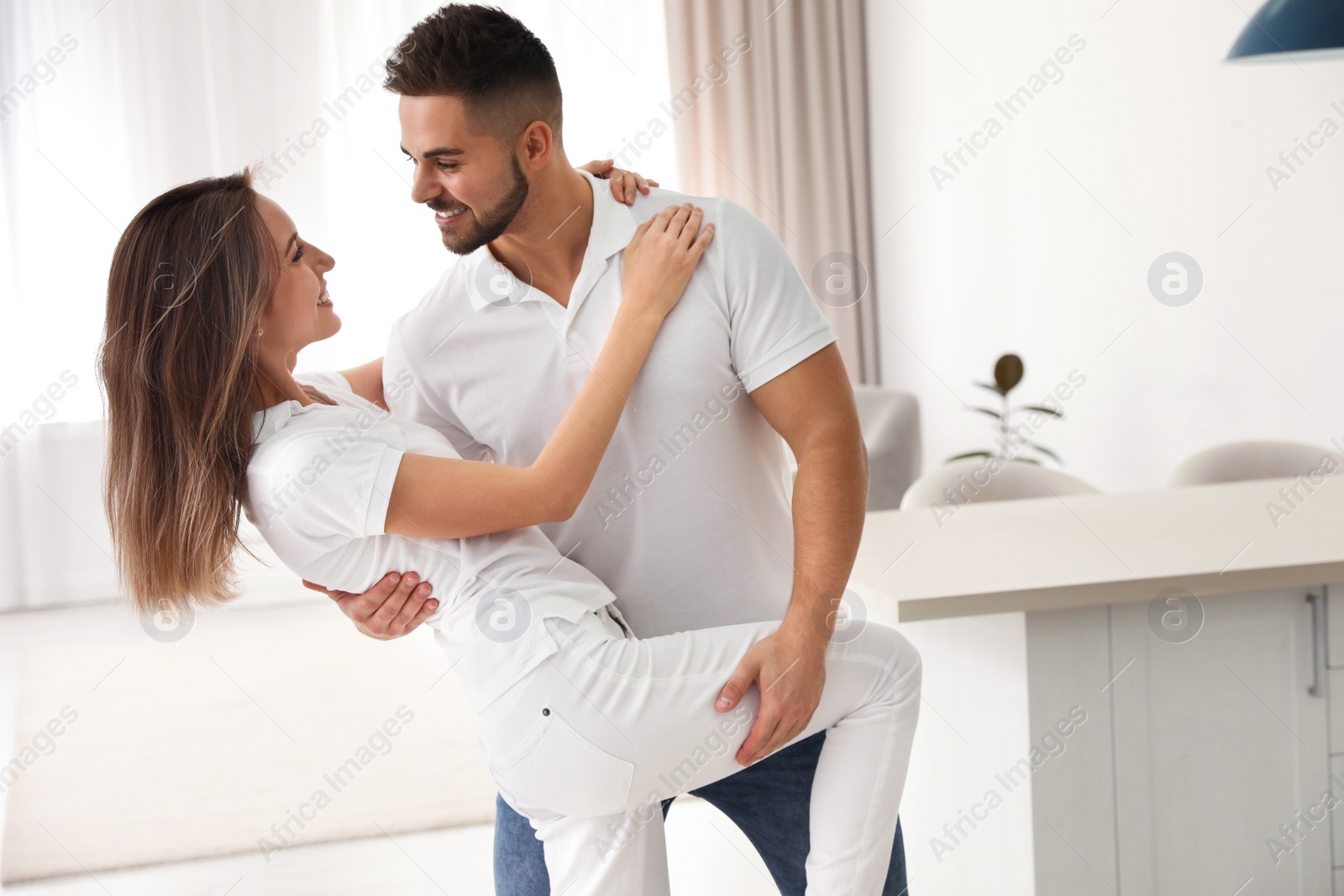 Photo of Lovely young couple dancing together at home