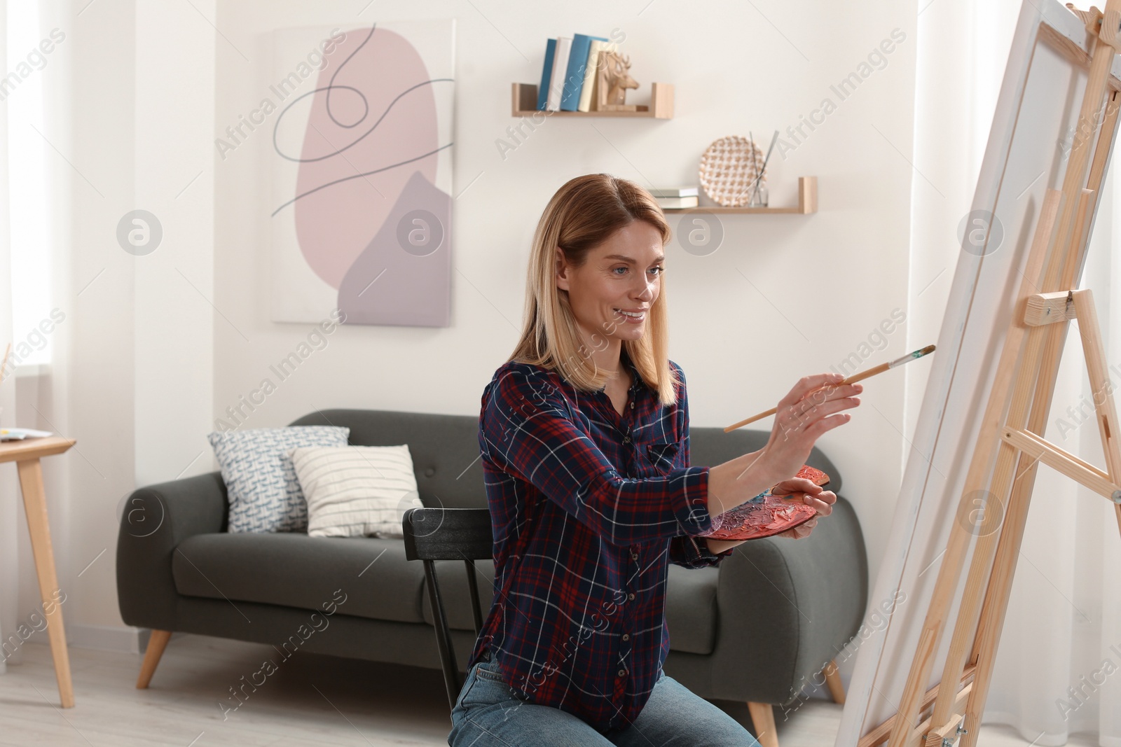 Photo of Beautiful woman painting in studio. Creative hobby