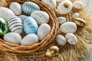 Photo of Decorative nest and many beautiful Easter eggs on table