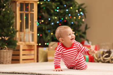 Cute little baby in room decorated for Christmas. Winter holiday