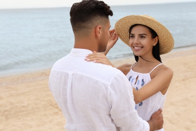 Photo of Lovely couple spending time together on beach