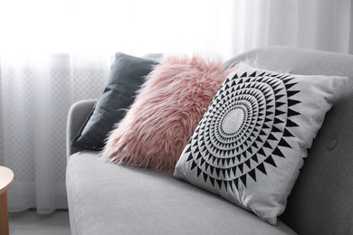 Soft pillows on modern sofa in living room