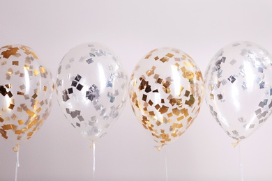 Photo of Color balloons with ribbons on white background