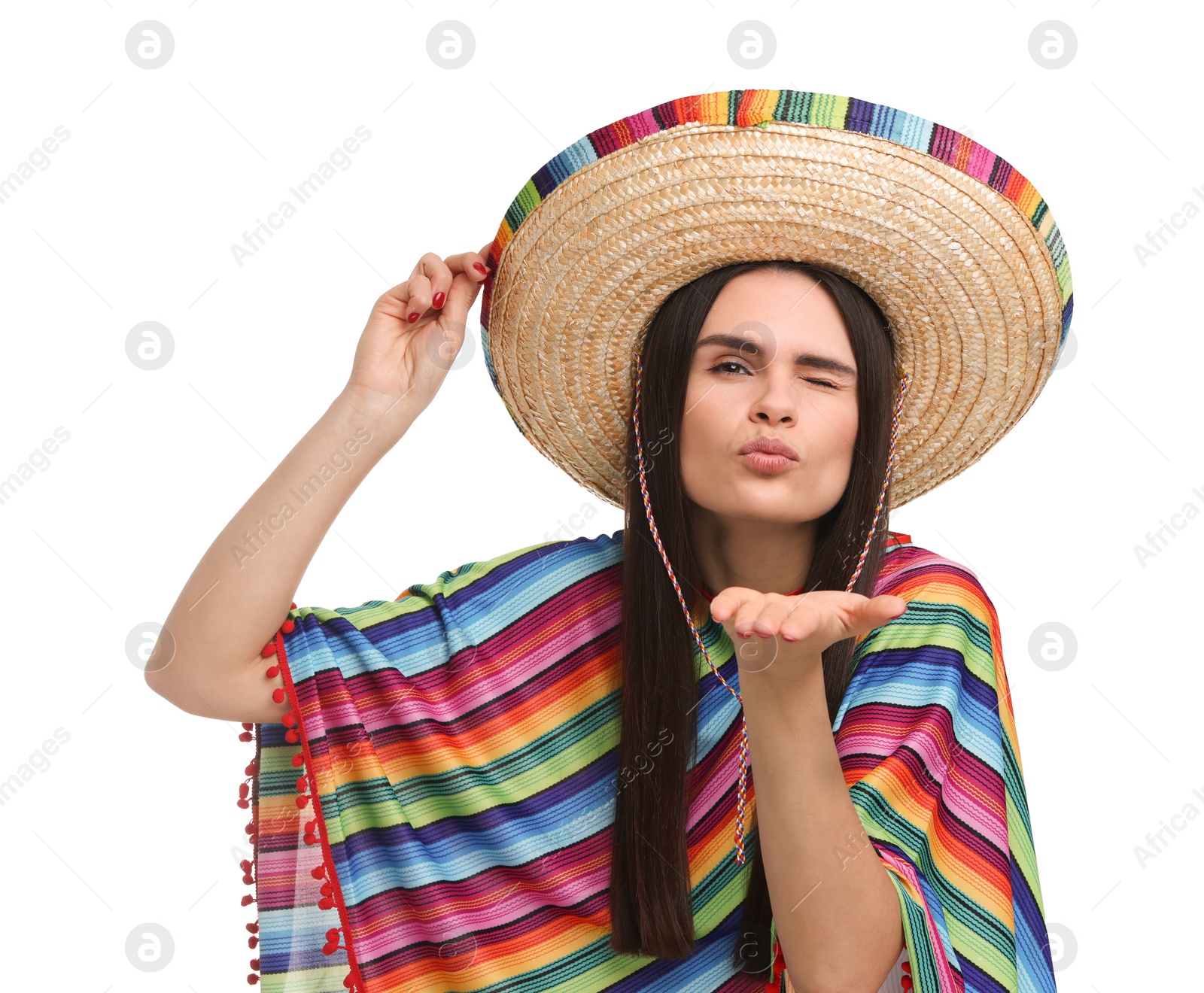 Photo of Young woman in Mexican sombrero hat and poncho blowing kiss on white background