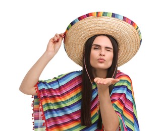 Photo of Young woman in Mexican sombrero hat and poncho blowing kiss on white background