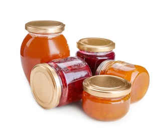 Jars with different sweet jam on white background