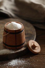 Photo of Organic salt in bowl on wooden table