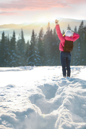 Young woman enjoying beautiful nature. Winter vacation