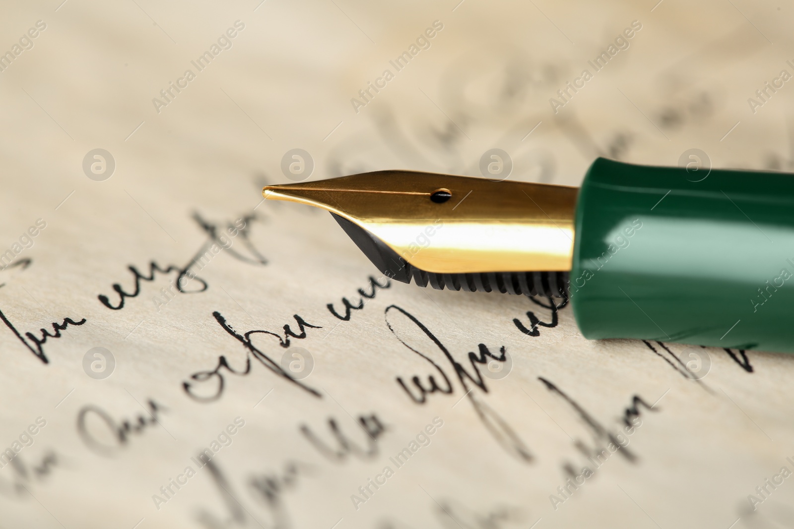 Photo of One fountain pen on handwritten letter, closeup