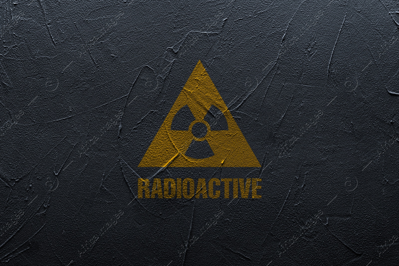 Image of Radioactive sign on black textured wall. Hazard symbol