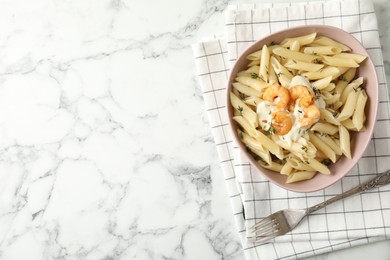 Delicious pasta with shrimps on white marble table, top view. Space for text