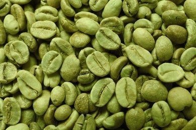 Photo of Many green coffee beans as background, top view