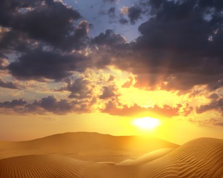 Image of Beautiful view of sandy desert at sunset