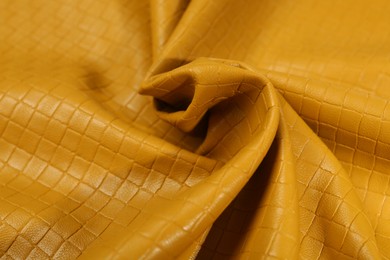 Photo of Beautiful yellow leather as background, closeup view