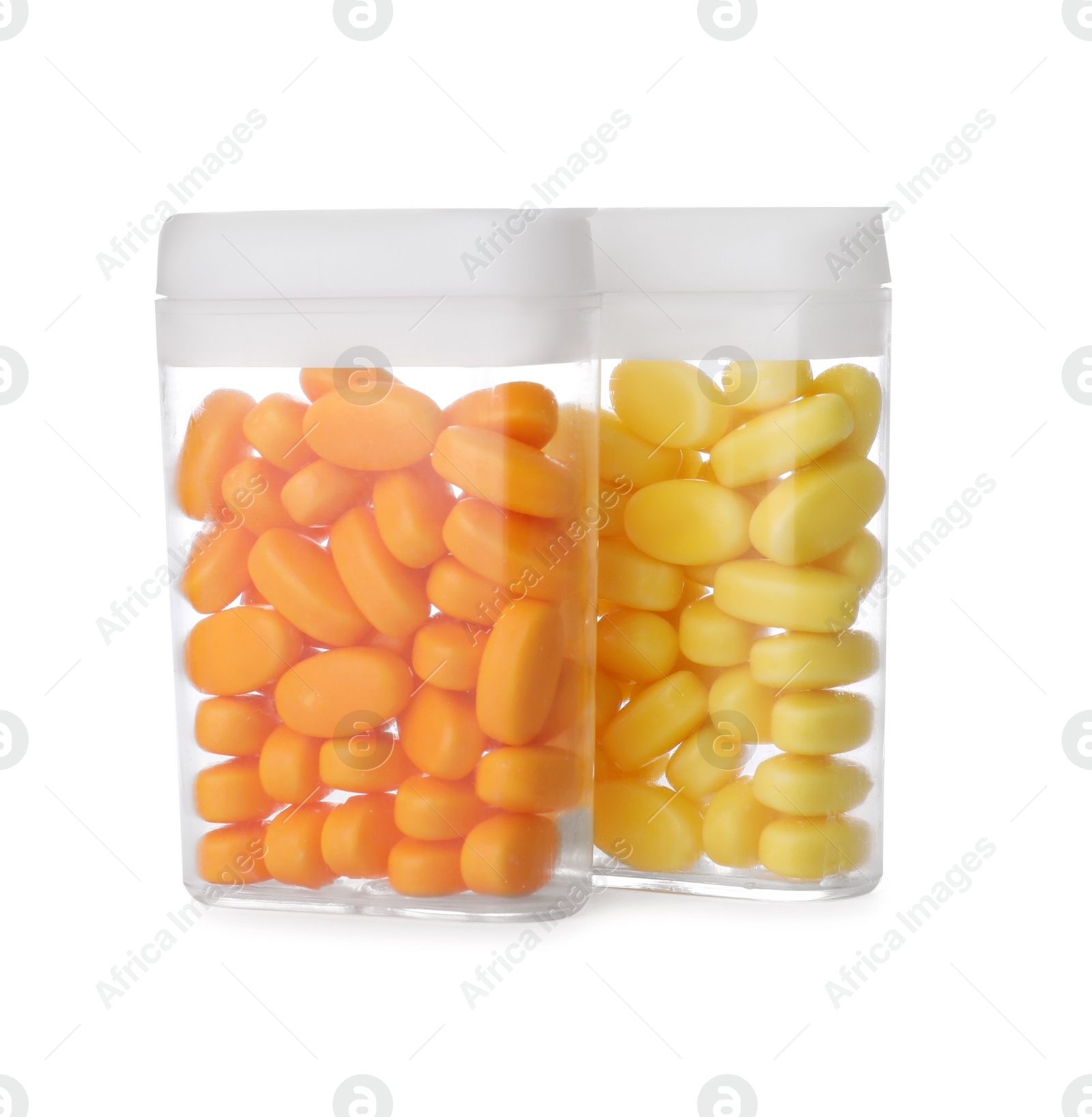 Photo of Boxes of orange and yellow dragee candies on white background