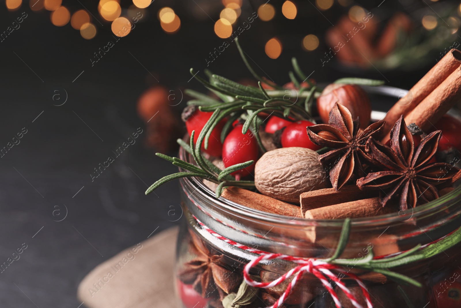 Photo of Aroma potpourri with different spices in jar, closeup view. Space for text