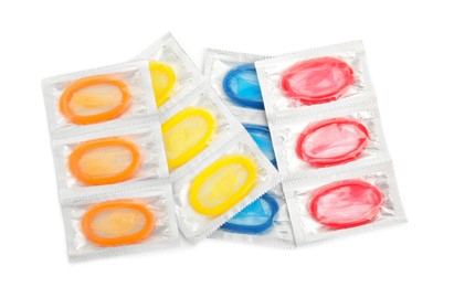 Photo of Condom packages on white background, top view. Safe sex