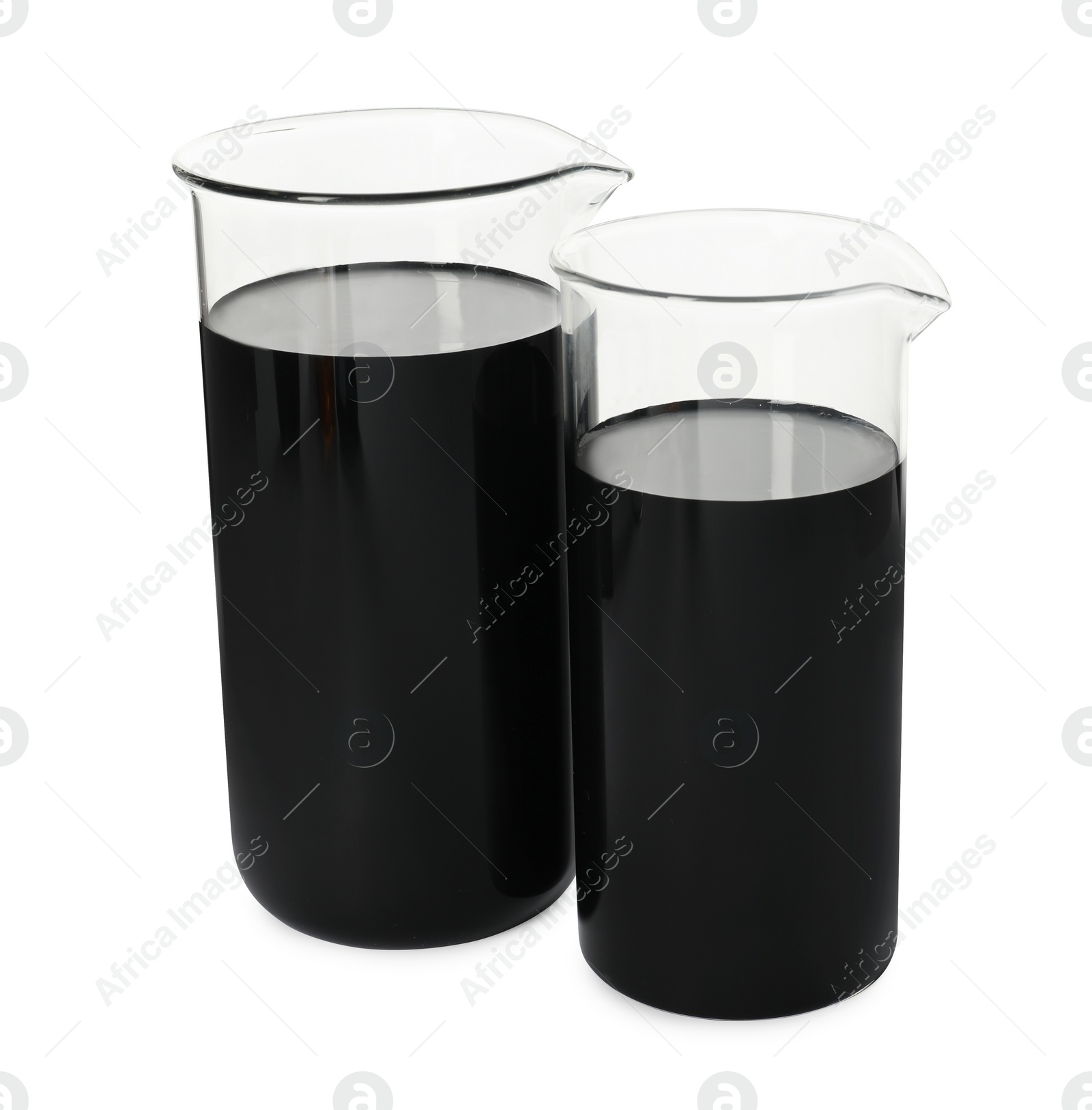 Photo of Beakers with black crude oil isolated on white