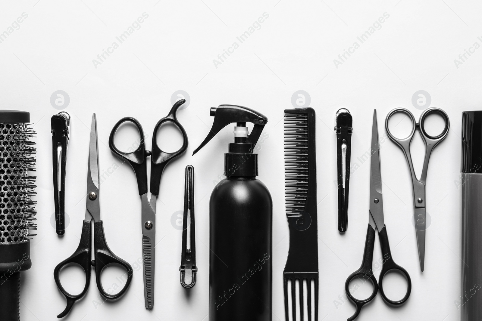 Photo of Composition with scissors and other hairdresser's accessories on white background, top view