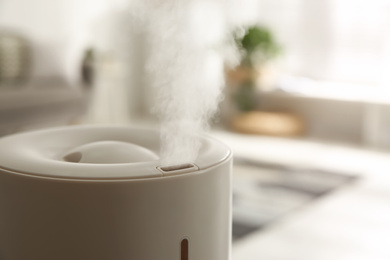 Photo of Modern humidifier indoors, closeup. Space for text