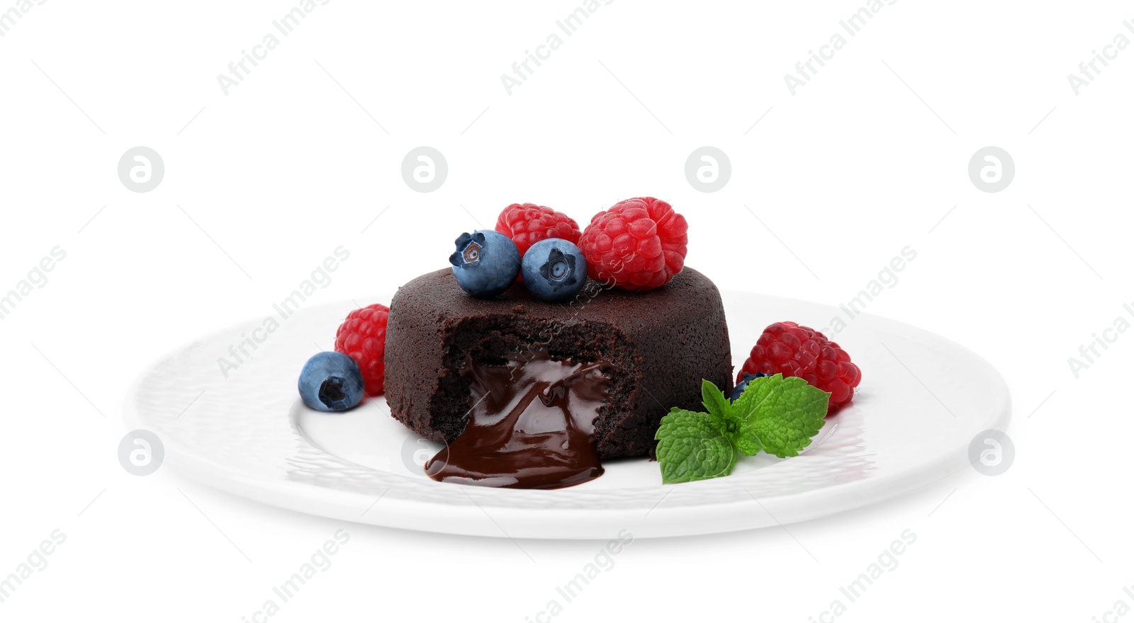 Photo of Plate with delicious chocolate fondant, berries and mint isolated on white