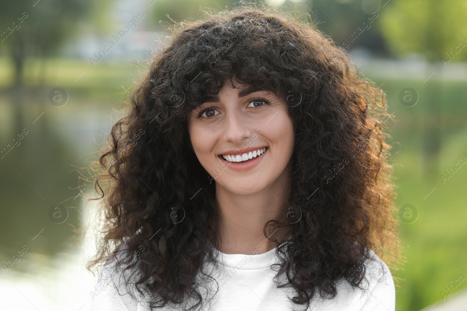 Photo of Portrait of beautiful woman outdoors. Attractive lady smiling and looking into camera