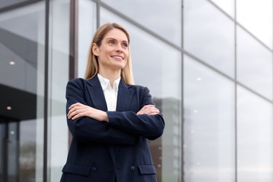 Photo of Happy real estate agent outdoors. Space for text