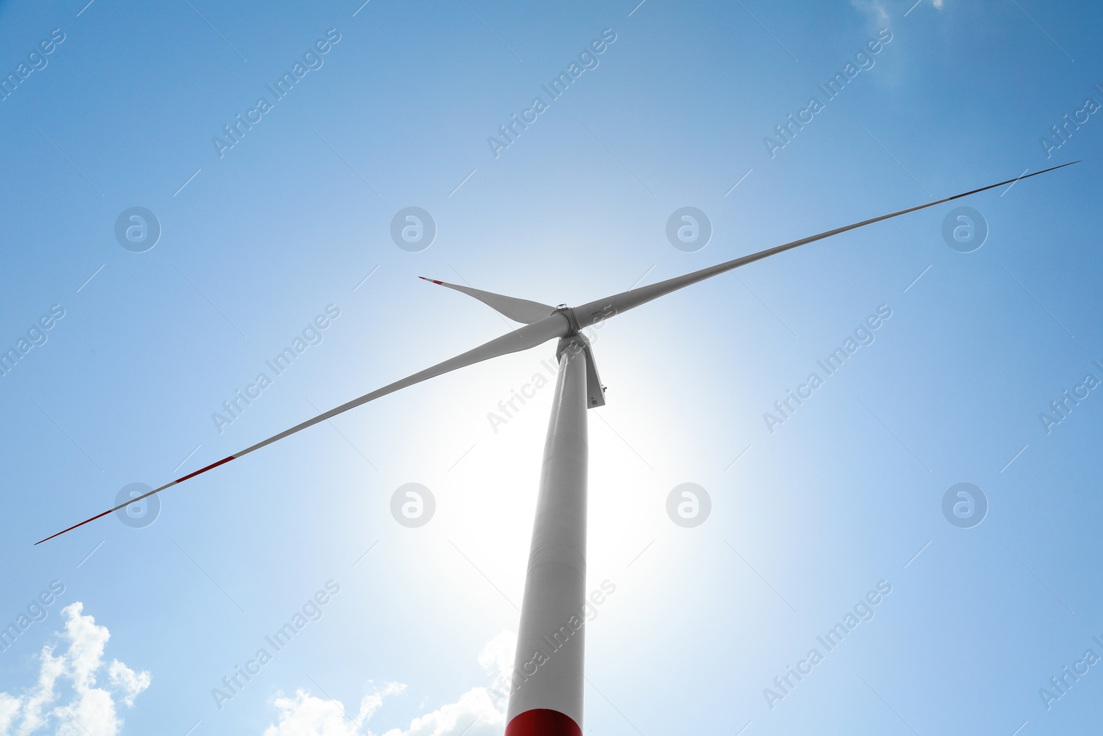 Photo of Modern wind turbine against blue sky, low angle view. Energy efficiency