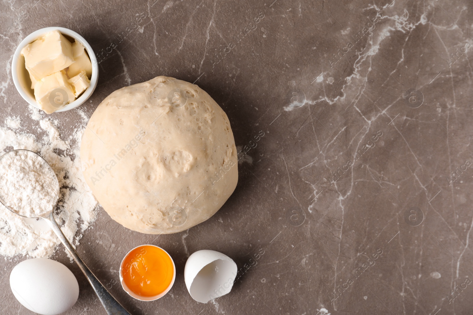 Photo of Flat lay composition with dough on marble table, space for text. Cooking pastries