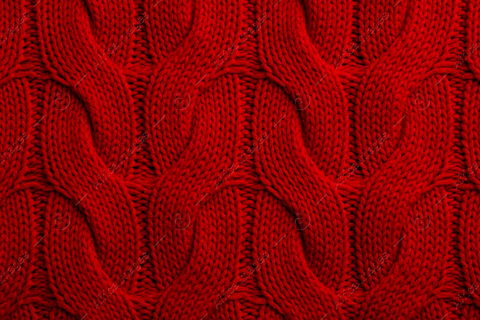 Photo of Beautiful red knitted fabric as background, top view