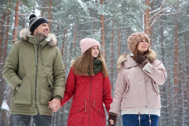 Photo of Happy family in forest on snow day