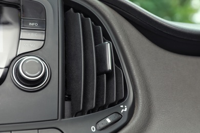 Photo of Modern air conditioning control panel in car, closeup