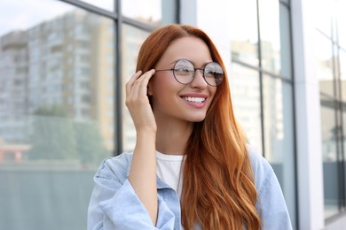 Portrait of beautiful woman in glasses outdoors