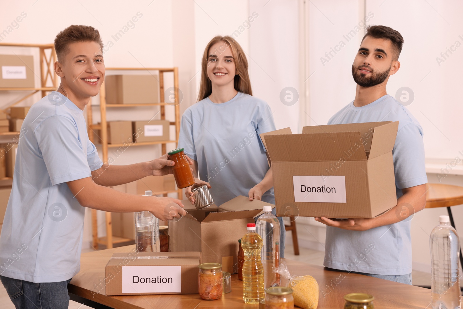 Photo of Portrait of volunteers packing food products in warehouse