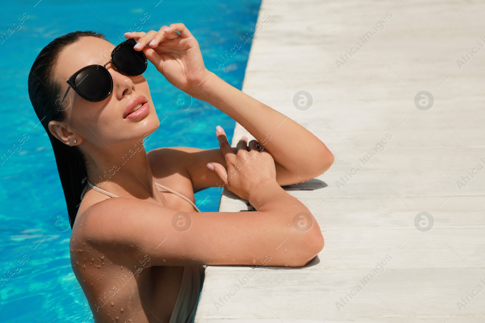 Photo of Beautiful woman wearing bikini in swimming pool