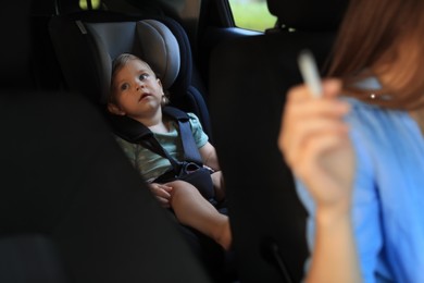 Mother with cigarette and child in car, closeup. Don't smoke near kids