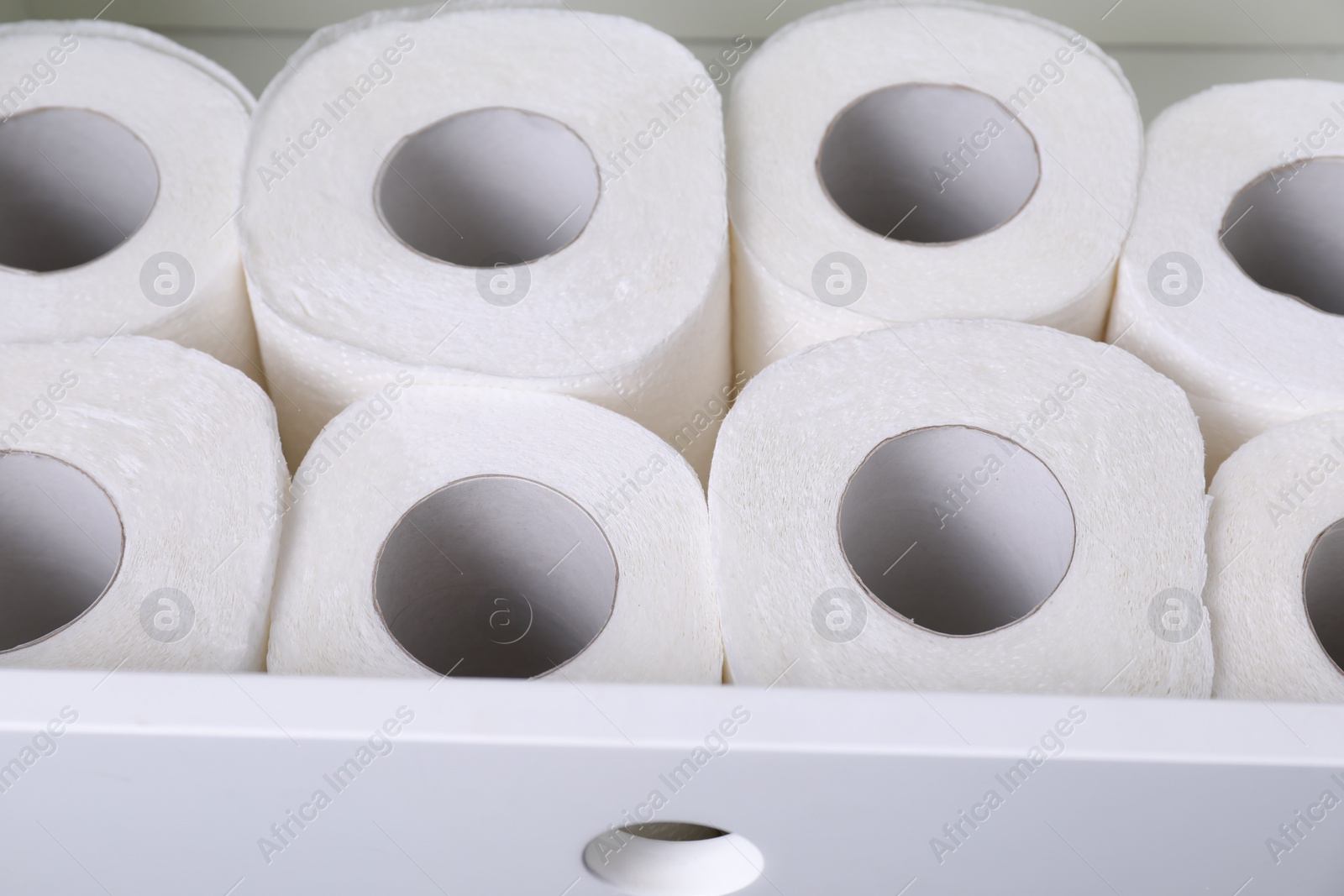 Photo of Many toilet paper rolls in white drawer indoors