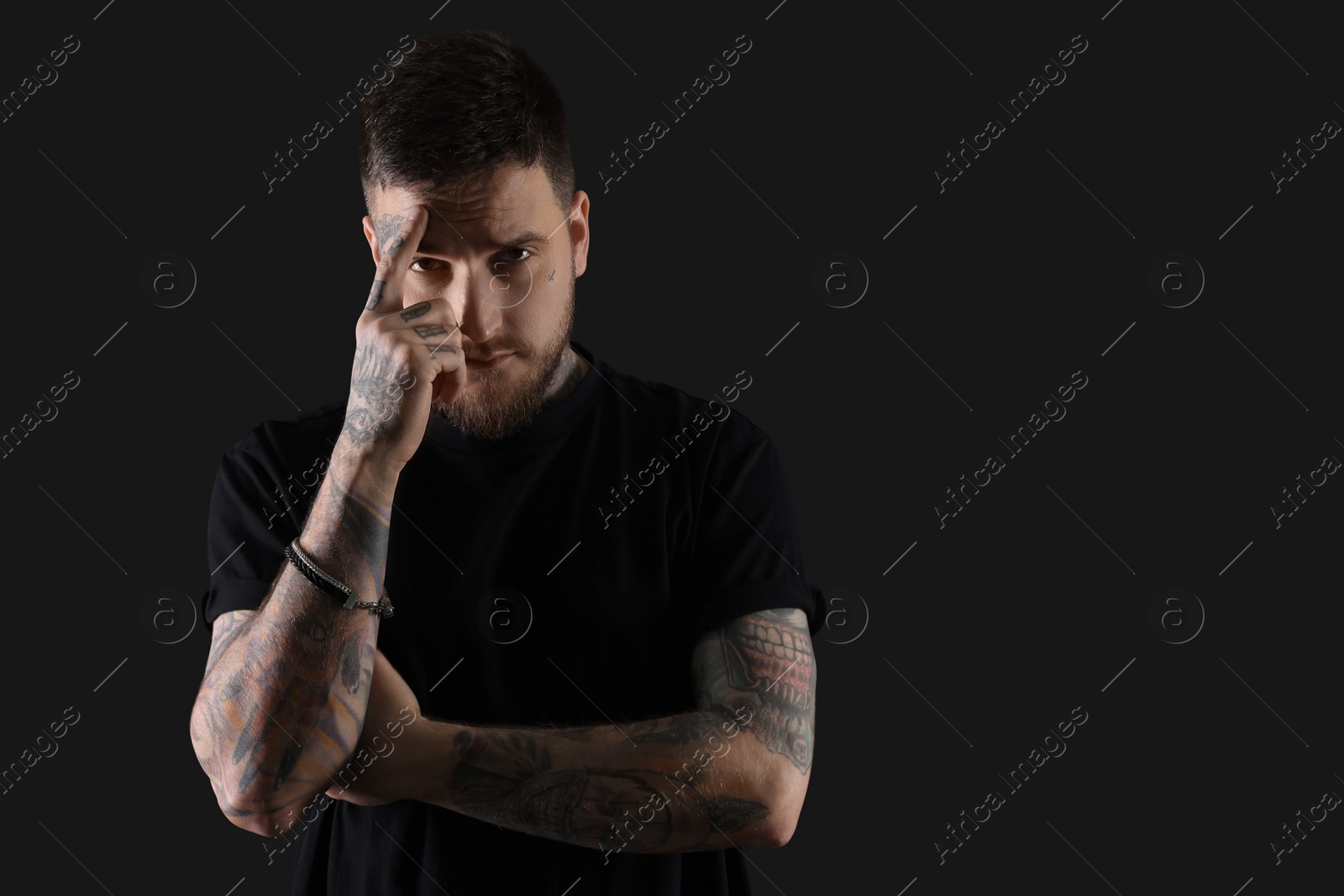 Photo of Portrait of handsome hipster man on black background. Space for text