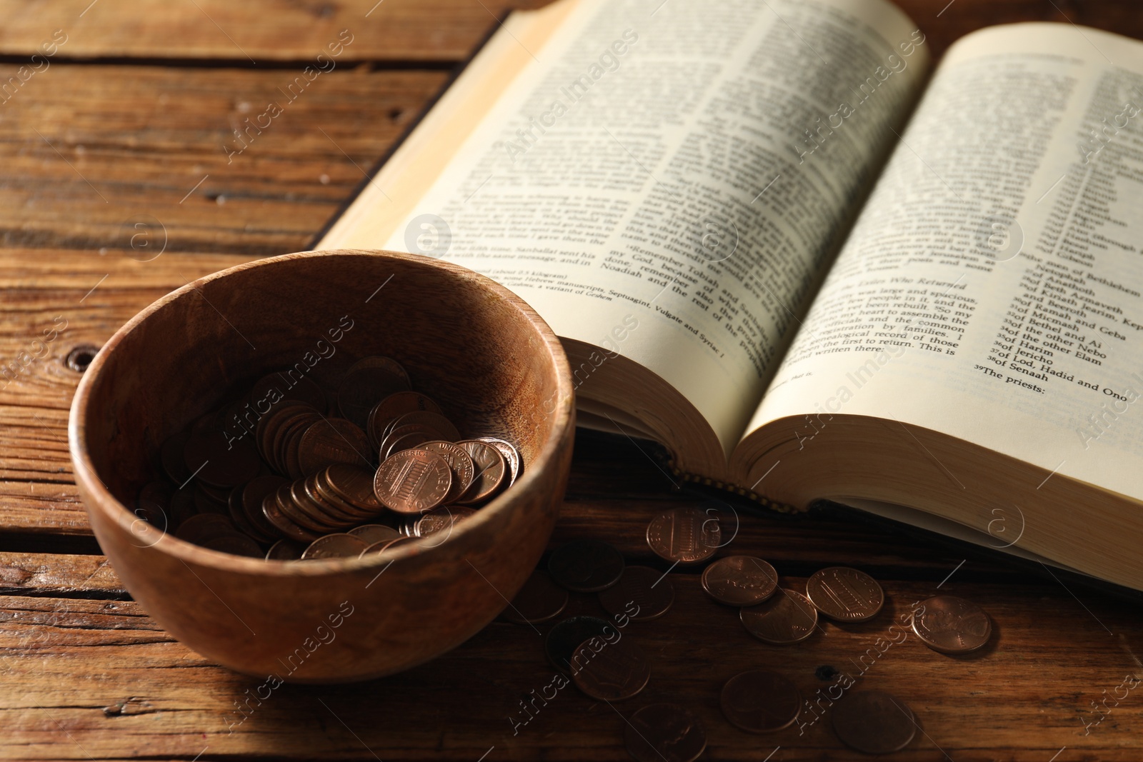 Photo of Donate and give concept. Bowl with coins and Bible on wooden table