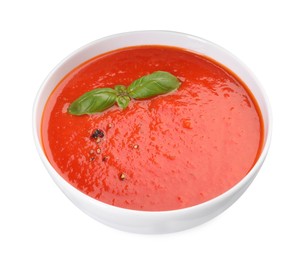 Photo of Delicious tomato cream soup in bowl isolated on white