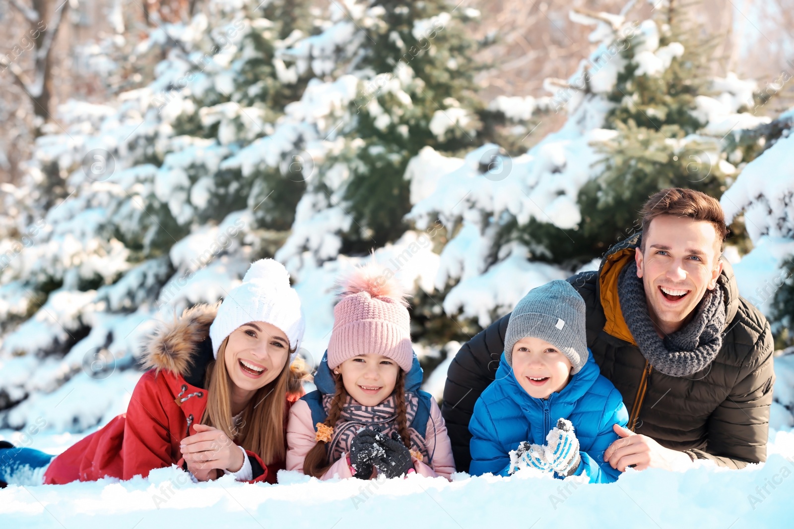 Photo of Portrait of happy family in winter park