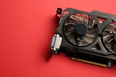 Photo of One graphics card on red background, top view. Space for text