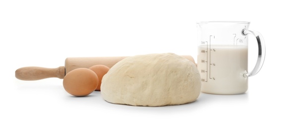 Composition with wheat dough and products on white background