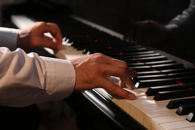 Photo of Man playing grand piano, closeup. Talented musician